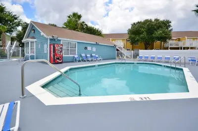 a swimming pool with a coke machine next to a building at Incredible Island Club Villa Condo in Kissimmee