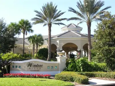 a building with palm trees in front of it at 3 Bedrooms Condo Only Minutes From Disney in Orlando