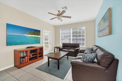a living room with a couch and a ceiling fan at 3 Bedrooms Condo Only Minutes From Disney in Orlando