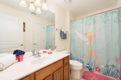 a bathroom with a fairy shower curtain and a sink at Windsor Hills Resort Pool Villa Near Disney in Orlando
