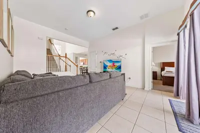 a living room with a couch and a bedroom at Windsor Hills Resort Pool Villa Near Disney in Orlando