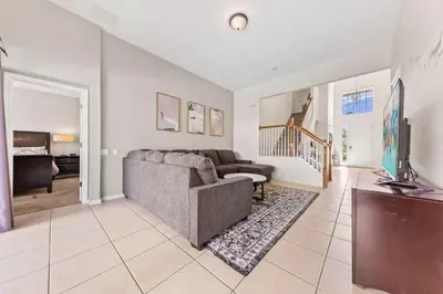 a living room with a couch and a television at Windsor Hills Resort Pool Villa Near Disney in Orlando