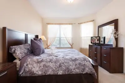a bedroom with a bed and a dresser and a window at Windsor Hills Resort Pool Villa Near Disney in Orlando