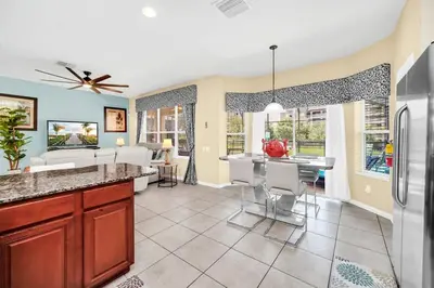 a kitchen and living room with a refrigerator at Windsor Hills Dream Private Screened Pool Home in Orlando