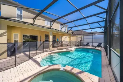 an indoor swimming pool with a glass roof at Luxury 6 Bedroom Pool Home in Windsor Hills in Orlando