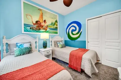 a bedroom with two beds and a painting on the wall at Newly Upgraded Disney Themed Vacation Retreat in Orlando