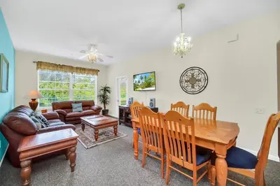 a living room with a table and a couch at 3 Bedroom 2 Bath Condo in Windsor Palms Resort in Kissimmee