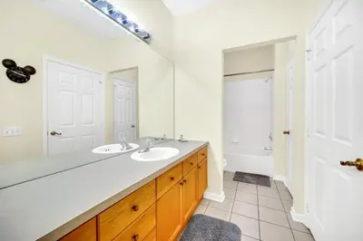 a bathroom with two sinks and a large mirror at 3 Bedroom 2 Bath Condo in Windsor Palms Resort in Kissimmee