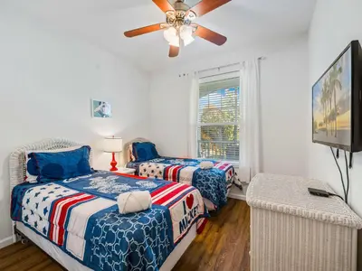 a bedroom with two beds and a ceiling fan at Newly Remodel Kitchen with All New Appliances in Kissimmee