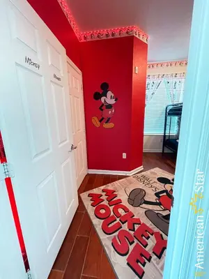 a room with a mickey mural on the wall at Cozy 3BR Apartment - Vista Cay Resort near Disney! in Orlando