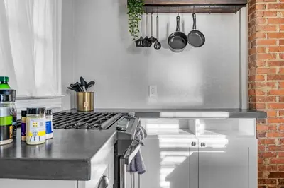 a kitchen with a stove and a counter top at Tiny Home w MIL suite - 3 MI to DT in Orlando