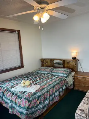 a bedroom with a bed and a ceiling fan at Red Brick House in Kissimmee