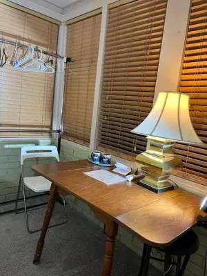 a wooden table with a lamp on top of it at Red Brick House in Kissimmee