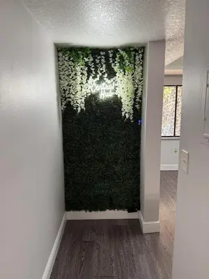 a living room with a green wall with ivy at Central Hub in Orlando
