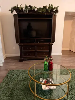 a living room with a glass table and a tv at Central Hub in Orlando