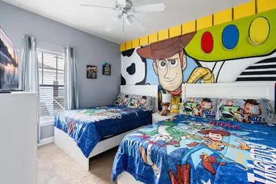 a bedroom with two beds and a large mural at Casa 4Q Lucaya com Temas Disney e Clubhouse in Kissimmee