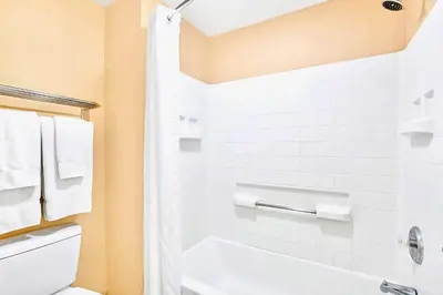 a bathroom with a white tub and a toilet at Apartment w Pool and Hot Tub - Near Disney in Orlando