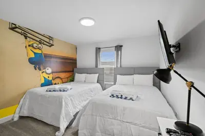 a bedroom with two beds with white sheets at Stunning home at Storey Lake close to Disney in Kissimmee