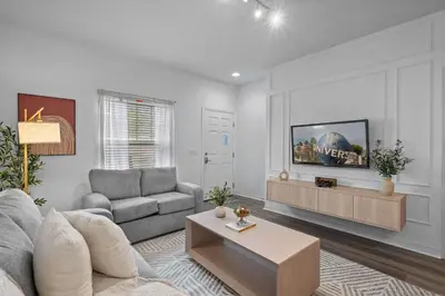 a living room with a couch and a table at Modern 3 Bed Villa Newly Renovated Prime Location in Kissimmee