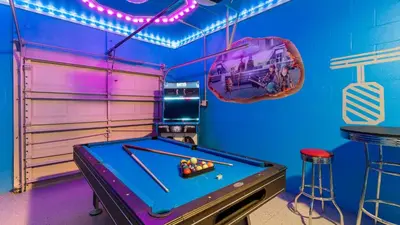 a game room with a pool table and a bar at Magic Moments in Kissimmee