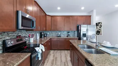 a kitchen with wooden cabinets and stainless steel appliances at Magic Moments in Kissimmee