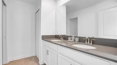 a bathroom with two sinks and a large mirror at Sierra Sky in Kissimmee