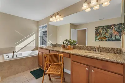 a bathroom with a sink and a mirror at 5BD - Movie Room, Pool, BBQ - Near Disney World in Kissimmee