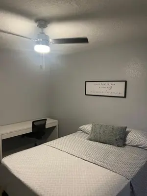 a bedroom with a bed and a ceiling fan at Cozy Haven with Premier Privacy 4 bedroom in Orlando