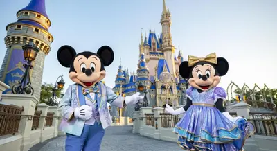 two people in mickey mouse costumes in front of disney castle at Cozy Haven with Premier Privacy 4 bedroom in Orlando
