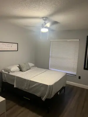 a bedroom with a bed and a ceiling fan at Cozy Haven with Premier Privacy 4 bedroom in Orlando