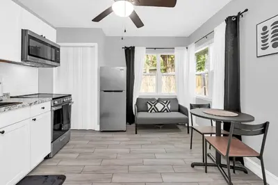 a kitchen with a table and a dining room at Modern Cuartito near Winter Park in Orlando