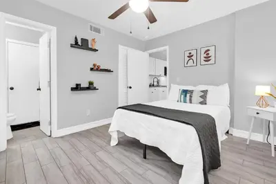 a white bedroom with a bed and a ceiling fan at Modern Cuartito near Winter Park in Orlando
