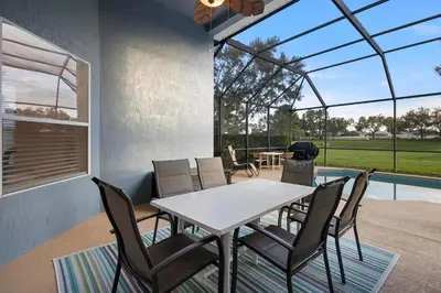 a dining room with a table and chairs at Lux 6BrVilla -Pool&ResortAmenities -10mins to Parks in Kissimmee