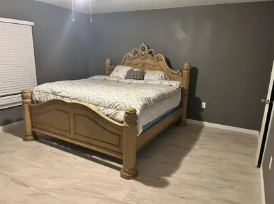 a bedroom with a wooden bed in a room at Tranquile Vacation Home near Universal studio in Orlando