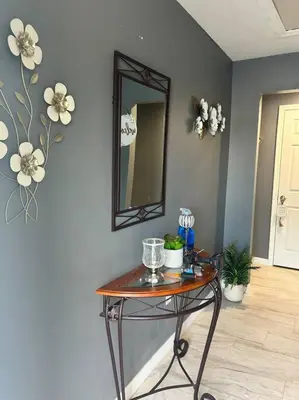 a table in a room with a mirror on the wall at Tranquile Vacation Home near Universal studio in Orlando