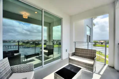 a balcony with two chairs and a view of the water at Storey Lake Resort 2bd Condo Overlooking Water #840 condo in Kissimmee