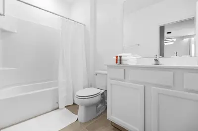 a white bathroom with a toilet and a sink at Brand NEW 9Bedrooms9Bathrooms At Paradiso Grande in Orlando