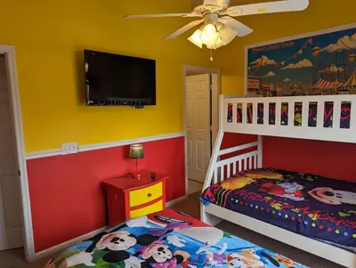 a bedroom with two bunk beds and a flat screen tv at La Dolce Vita Gated resort in Orlando