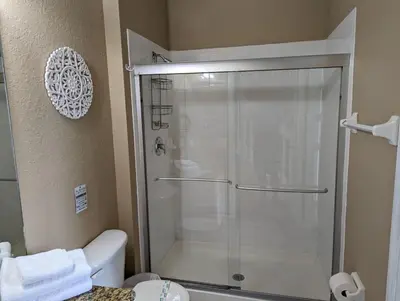 a shower with a glass door in a bathroom at La Dolce Vita Gated resort in Orlando