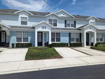 a large white house with a driveway at La Dolce Vita Gated resort in Orlando