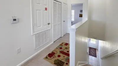 a hallway with a white door and a rug at Tequilla Sunrise at Windsor Hills in Orlando