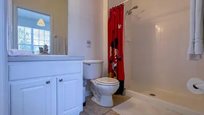 a bathroom with a toilet and a sink and a shower at Tequilla Sunrise at Windsor Hills in Orlando