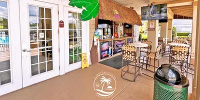 a restaurant with a bar with chairs and tables at Villas Standard Seven Dwrafs Resort - Close to Disney in Kissimmee