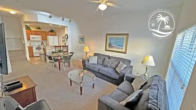 a living room with a couch and a table at Villas Standard Seven Dwrafs Resort - Close to Disney in Kissimmee