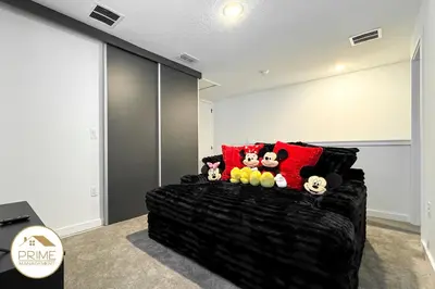 a black bed with stuffed animals on it in a room at New 3BD3BA Townhouse Themed Near Disney in Kissimmee