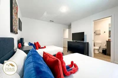 a living room with two beds and a blue couch at New 3BD3BA Townhouse Themed Near Disney in Kissimmee