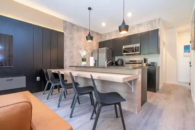 a kitchen with a table and chairs in a room at 3221 Brand New Family 3BD Townhouse near Disney in Kissimmee