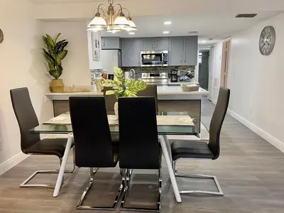 a kitchen and dining room with a table and chairs at Luxury Getaway 3BR Apartment near Disney Parks in Kissimmee