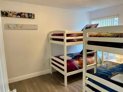 two bunk beds in a room with a bunk bed at Luxury Getaway 3BR Apartment near Disney Parks in Kissimmee