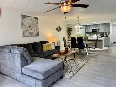 a living room with a couch and a table at Luxury Getaway 3BR Apartment near Disney Parks in Kissimmee